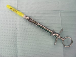 Syringe with a capped needle